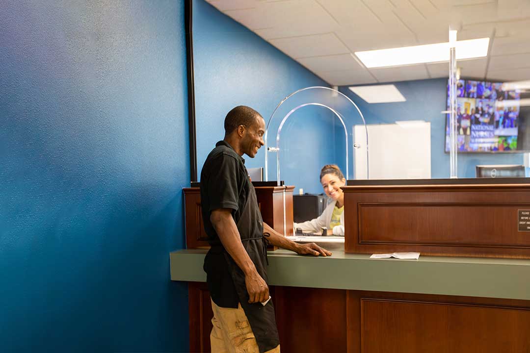 man standing at the teller window